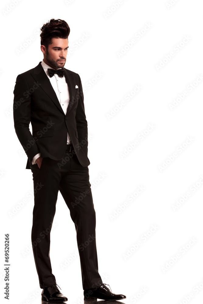 Poster fashion man in tuxedo looking to his side