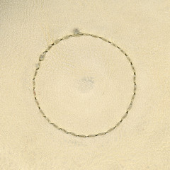 seam in the form of a circle on a beige leather background