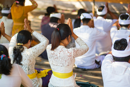 Young Balinese women praying in a temple