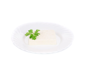 Tofu with parsley on a plate.