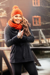 Smiling woman standing in autumn scenery