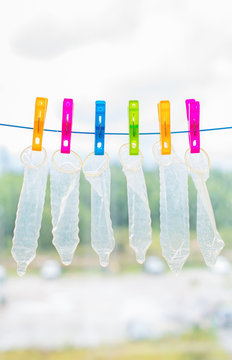 Six condoms drying on the rope. Funny conceptual photo.