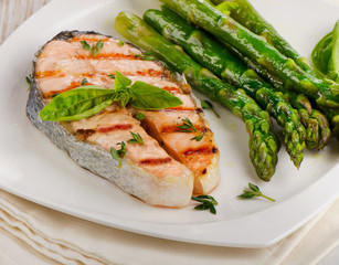 Grilled salmon with asparagus  on a white plate