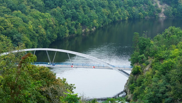 Bridge over the river surrounded by the mixed forest