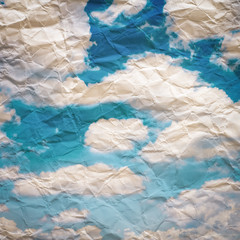 Grunge paper texture. with s white puffy clouds