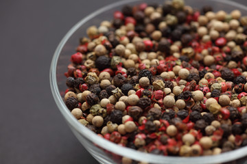 Mixed peppercorns in a glass bowl