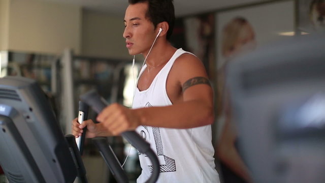 attractive young man exercising in the gym