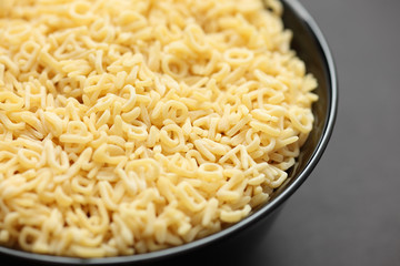 Raw alphabet soup pasta in a bowl