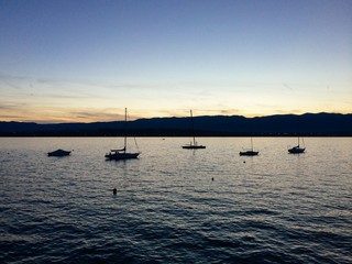Sunset and sailing boats
