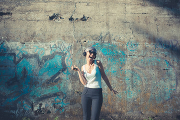 young beautiful short blue hair hipster woman with headphones mu