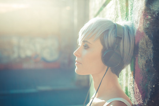 young beautiful short blue hair hipster woman with headphones mu