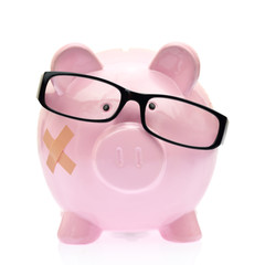 Piggy bank with eyeglasses and bandage