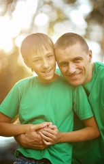 Father and son in summer park