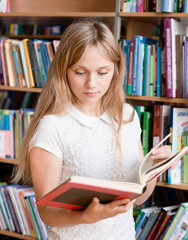  female student reading book in library
