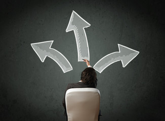 Businessman deciding with arrows above his head
