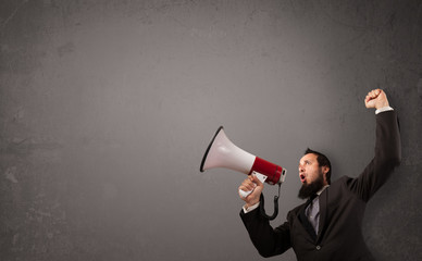 Guy shouting into megaphone on copy space background
