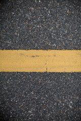Asphalt road with marking lines. Close-up background texture