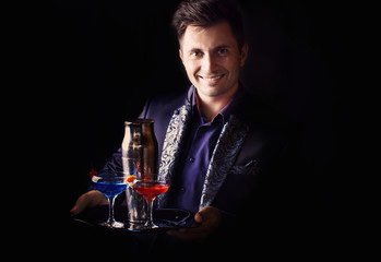 barman with shaker and a glasses on a black background
