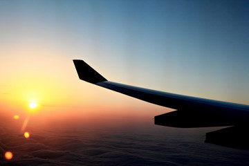 Sunset over the wing in airplane