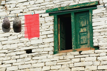 Caps and red fabric on clothesline. Ghandruk-Nepal. 0610