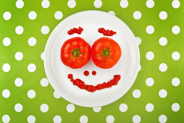 Ripe tomato as smiley emoticon