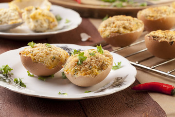 Baked eggs, stuffed with ham and parsley
