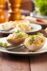 Baked eggs, stuffed with ham and parsley