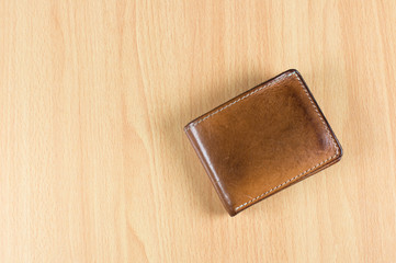 Old leather wallet on the wood