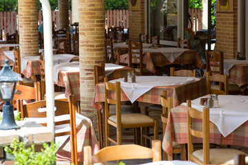 Empty oudoor cafe tables with selective focus