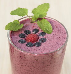 Cocktail of blueberries, raspberries and lemon balm with yogurt