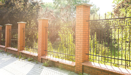 fence of red brick in the early morning