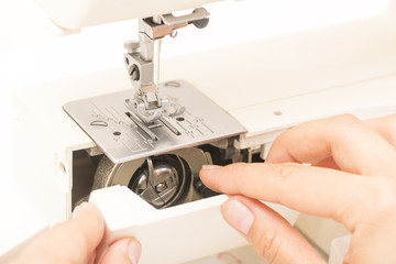 sewing machine and woman's hands