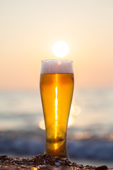 Glass of beer on a sunset