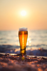 Glass of beer on a sunset