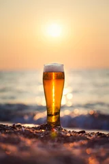 Fotobehang Glass of beer on a sunset © merydolla