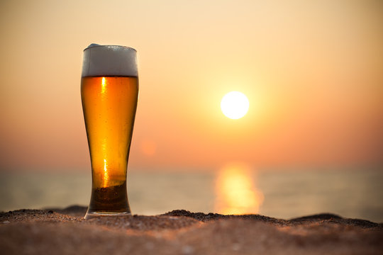 Glass of beer on a sunset