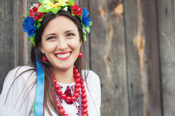beautiful young woman wearing national ukrainian clothes sitting