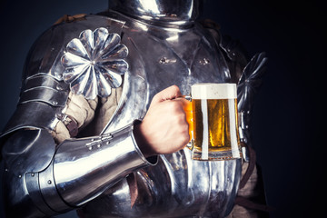 knight wearing armor and holding mug of beer