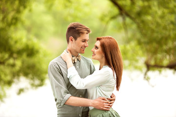 Fototapeta premium Couple in love walk near the riverr, smiling . Valentine's Day