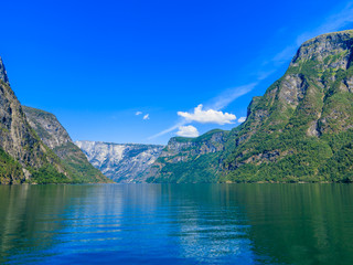 Naklejka na ściany i meble Tourism and travel. Mountains and fjord in Norway.