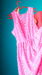 Closeup of pink dress in female hand. Sale retail.