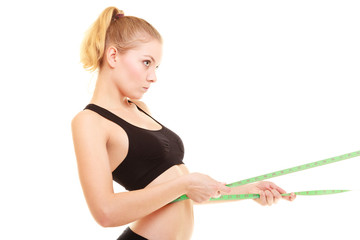 diet. slim blonde girl with measure tape measuring waist