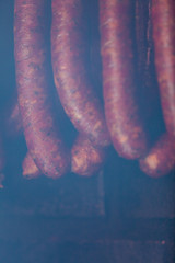 Traditional food. Smoked sausuages in smokehouse.