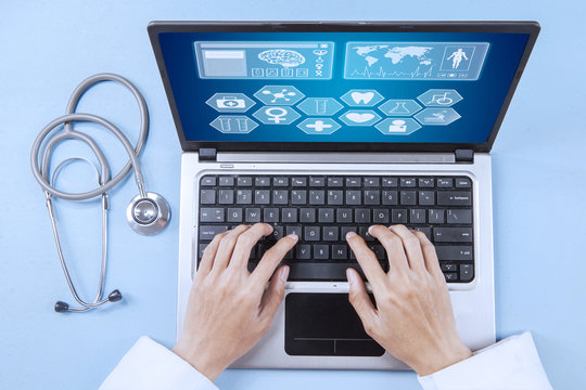 Doctor analyzing human illness on laptop