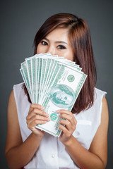 Beautiful Asian girl hold over size 100 dollar bills