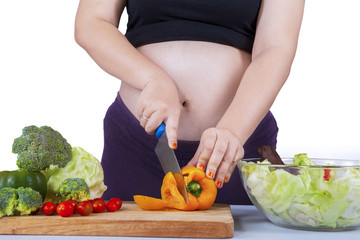 Pregnant woman cooking salad 2