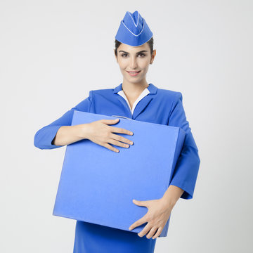 Charming Stewardess Dressed In Blue Uniform And Suitcase