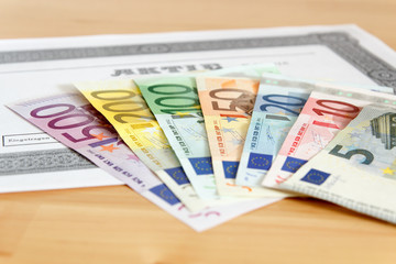 Aktie mit aufgefächerten Geldscheinen und geringer Tiefenschärfe