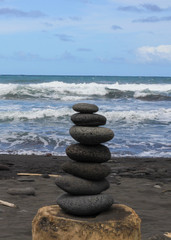 Fototapeta na wymiar Hawaiian Stacked Stones on Black Sand