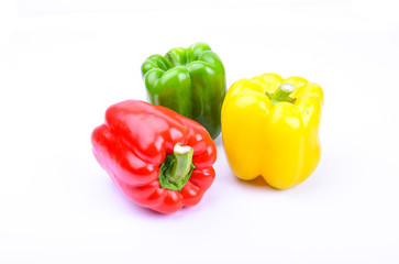 red, green and yellow paprika on a white screen